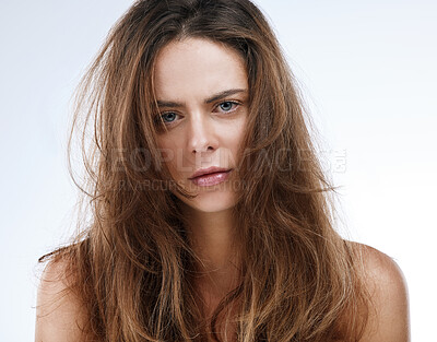 Buy stock photo Portrait, messy hair and frustration with an unhappy woman in studio on a white background for beauty. Damaged, split ends or frizz and a young person looking upset with her haircare treatment