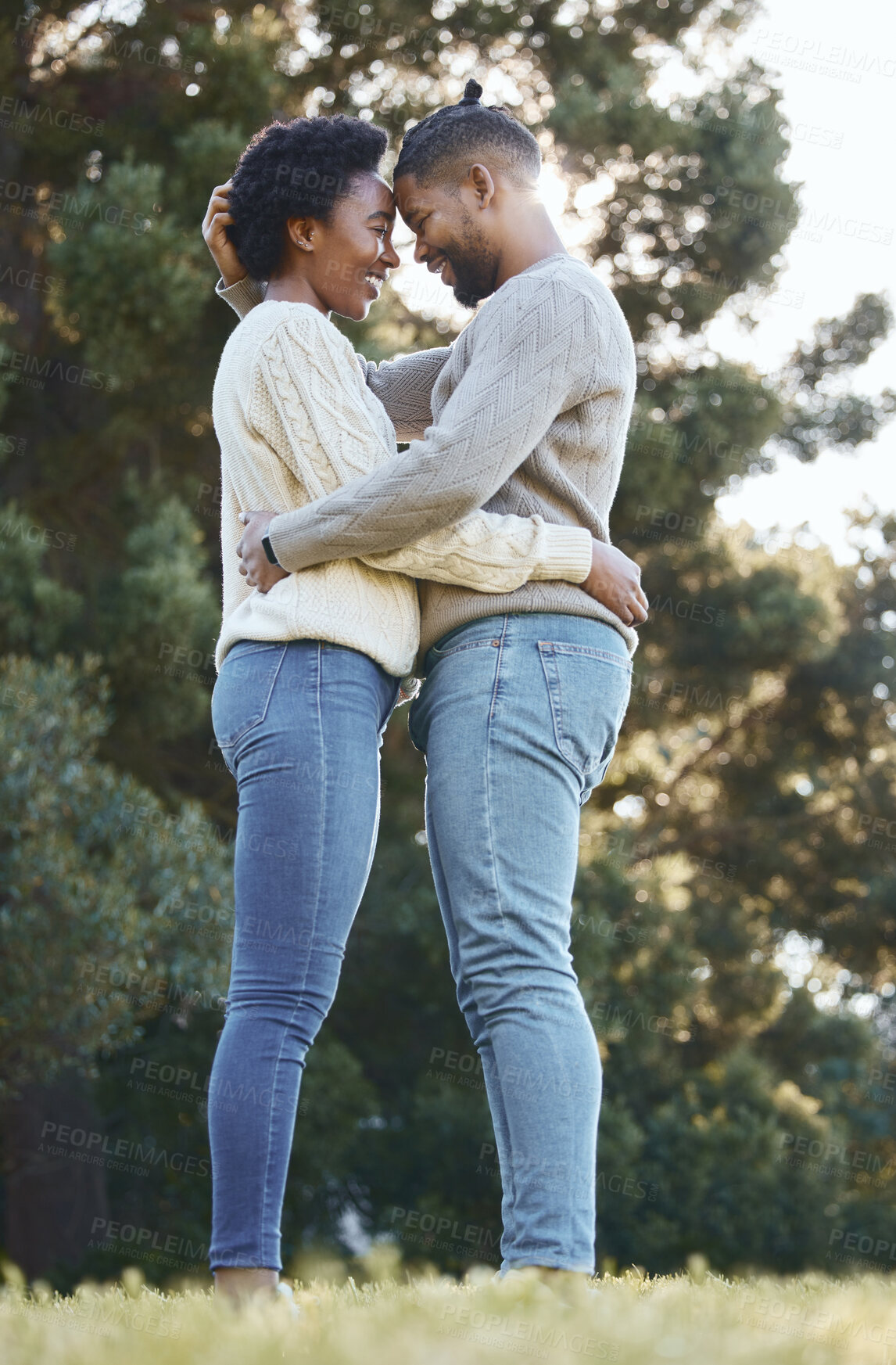 Buy stock photo Couple, hug and happy in countryside for love, holiday and adventure or winter camping trip. Black man, woman and embrace outdoor for support, comfort and together with care and smile in forest 