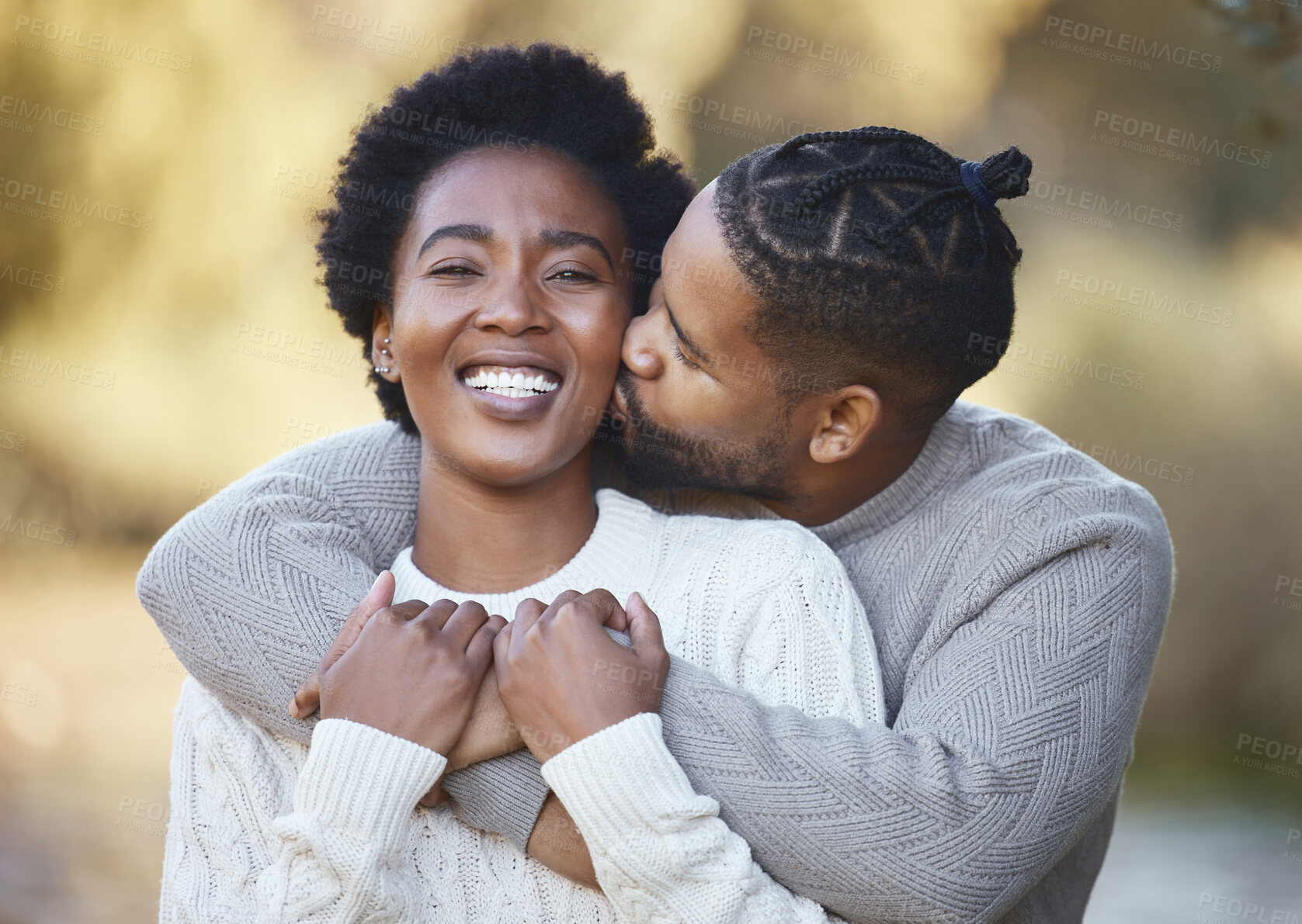 Buy stock photo Portrait, woman and kiss in countryside for love, holiday and adventure or winter camping trip. Black man, couple and embrace outdoor for support, comfort and together with hug and smile in forest 