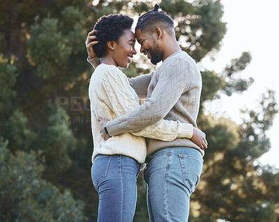 Buy stock photo Shot of a young man hugging his wife doing a camping trip