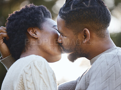 Buy stock photo Shot of a young couple kissing during a camping trip