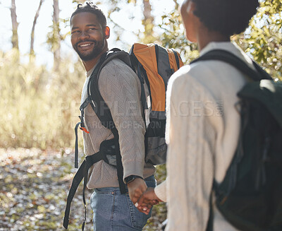 Buy stock photo Shot of a young couple going for a hike during a camping trip