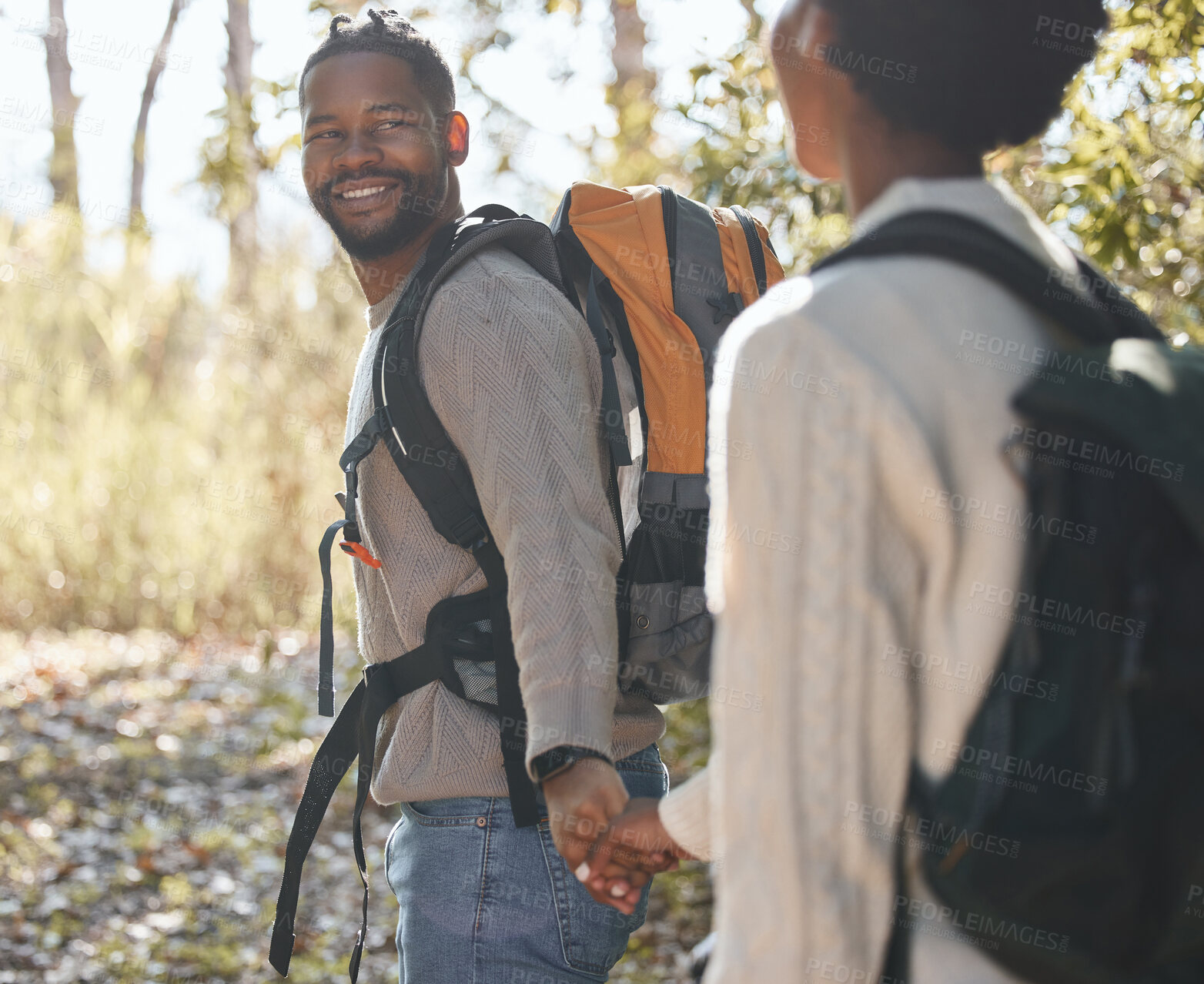 Buy stock photo Shot of a young couple going for a hike during a camping trip