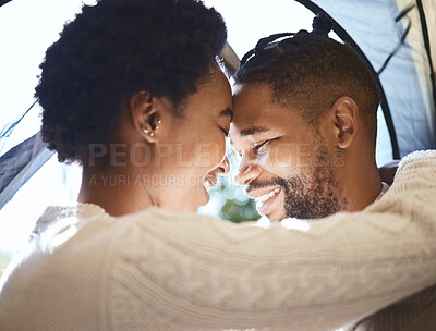 Buy stock photo Shot of a young couple spending time together in their tent while camping