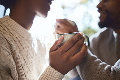 Buy stock photo Shot of a couple enjoying a cup of tea in their tent during a camping trip