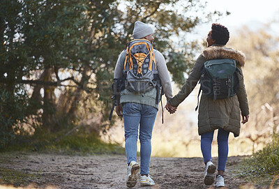 Buy stock photo Shot of a young couple going for a hike during a camping trip