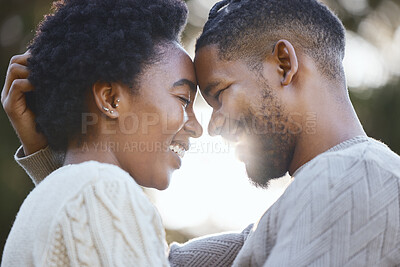 Buy stock photo Shot of a young couple being loving while camping together