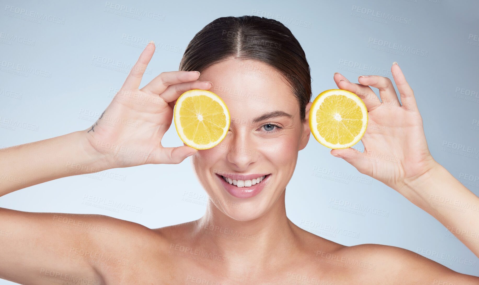 Buy stock photo Happy portrait, woman and lemon for skincare with vegan diet, healthy nutrition and beauty in studio. Model smile, citrus fruit and dermatology for vitamin c glow, shine and detox by gray background