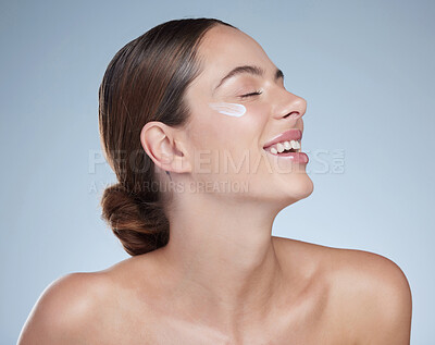 Buy stock photo Woman, dermatology and cream for clear skin in studio, hydration and beauty on blue background. Female person, sunscreen and lotion for facial treatment, skincare and hyaluronic acid moisturizer