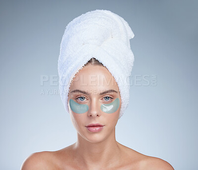 Buy stock photo Woman, eye patches and portrait for grooming in studio, facial treatment and hydration on blue background. Female person, skincare and beauty mask for moisture, vitamin e and pads for cosmetics