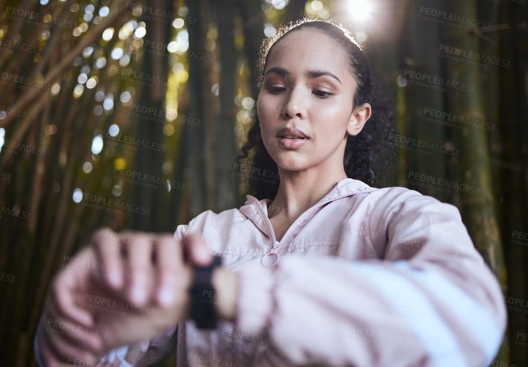 Buy stock photo Shot of a sporty young woman checking her watch