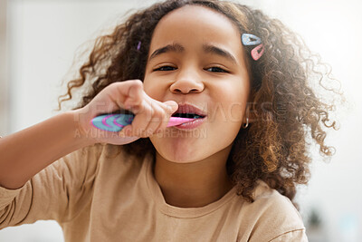 Buy stock photo Portrait of an adorable little girl brushing her teeth in a bathroom at home