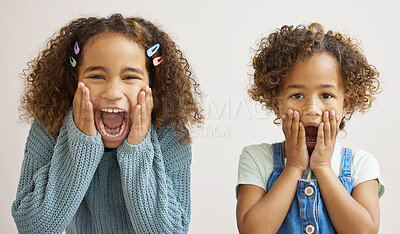 Buy stock photo Shot of two adorable little girls standing together and looking surprised