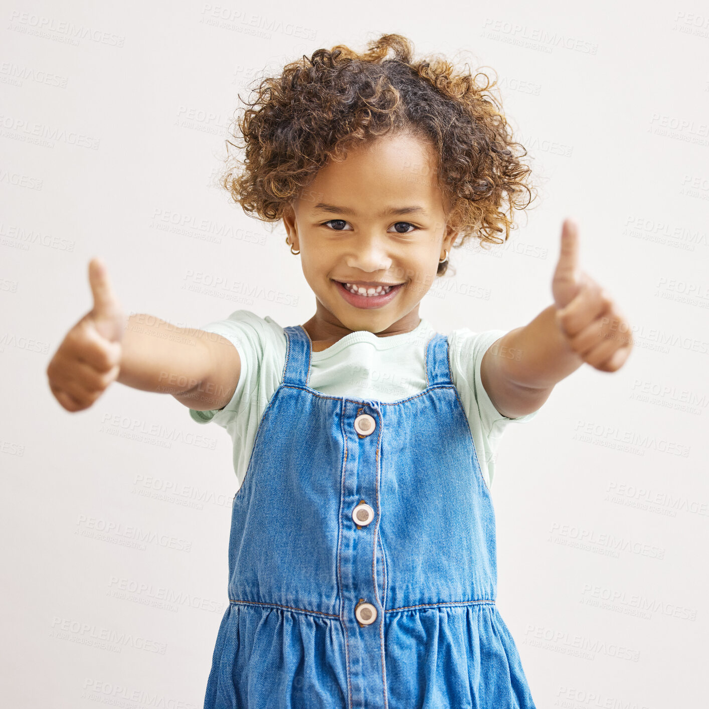 Buy stock photo Girl, happiness and studio with portrait or thumbs up for support, smile with like or approval. Female child, white background and satisfaction with hand gesture or vote, excited yes or agreement