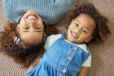 Buy stock photo High angle shot of two adorable little girls lying on the floor together