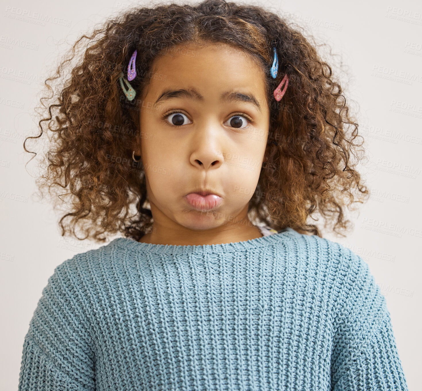 Buy stock photo Child, portrait and funny face in studio for goofy, silly and playful facial expression on white background. Youth, crazy and young girl with puffed cheeks for comic, humor and joking for comedy