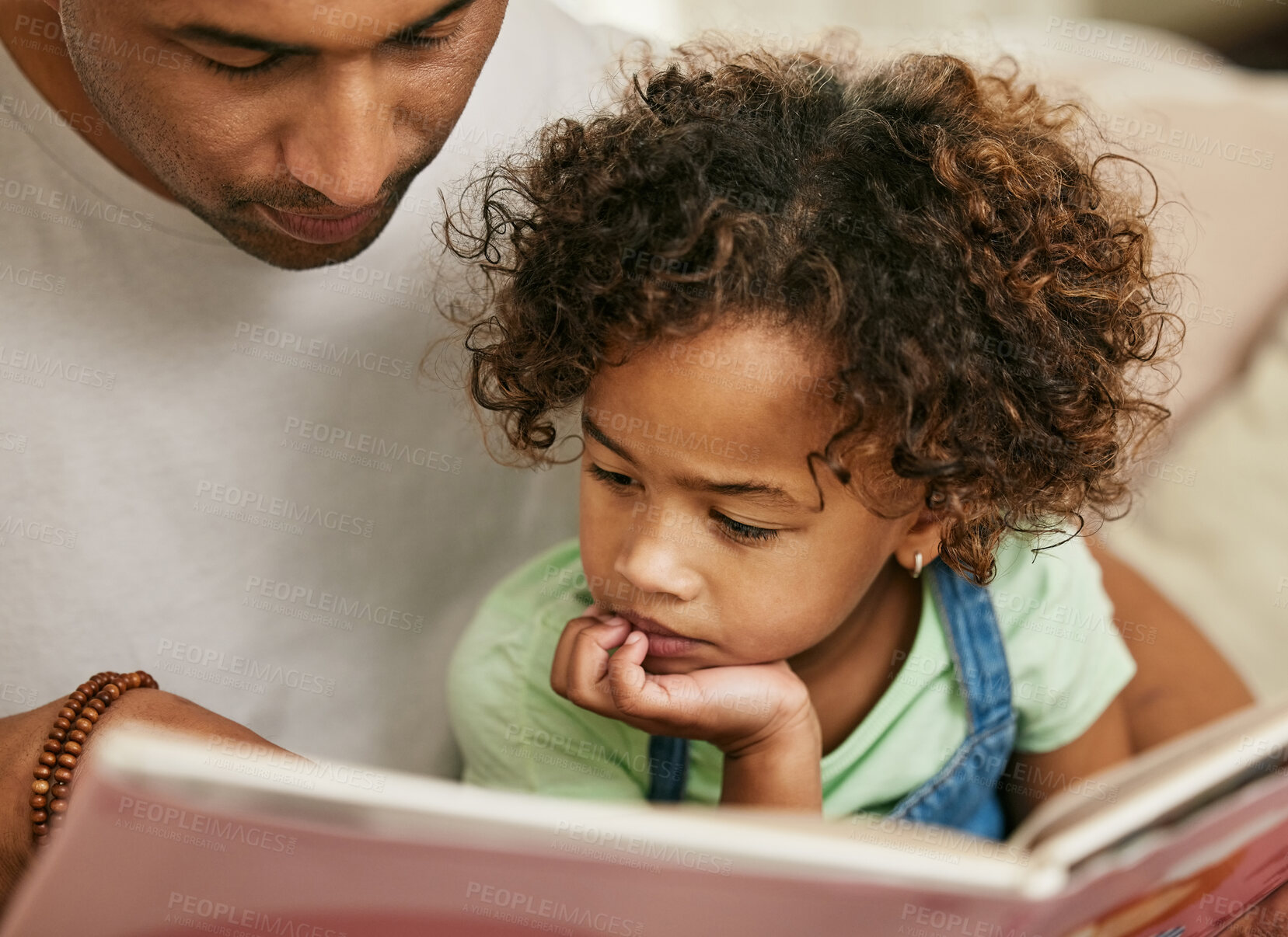 Buy stock photo Father, daughter and reading book in home for family bonding, learning and development in lounge. Man, kid and together in house for storytelling with fairytale, parent teaching for childhood growth