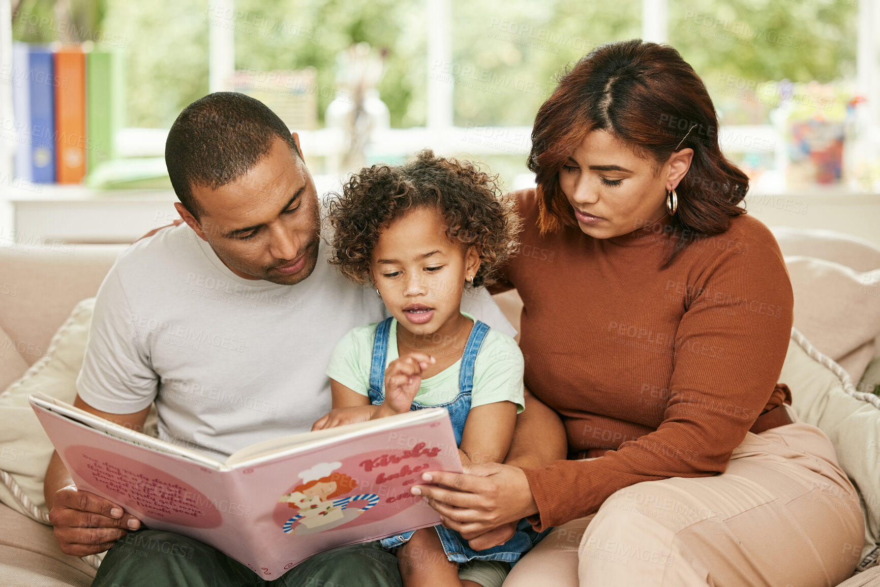 Buy stock photo Father, Mom and child with reading book on sofa for family bonding, learning and development in lounge. Parents, kids and together in home for storytelling, parent teaching or childhood growth