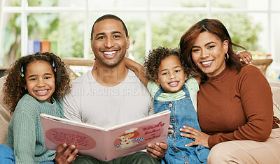 Buy stock photo Shot of a young family reading a book at home