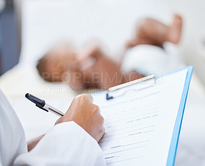 Buy stock photo Shot of a doctor making notes about her infant patient on a clipboard