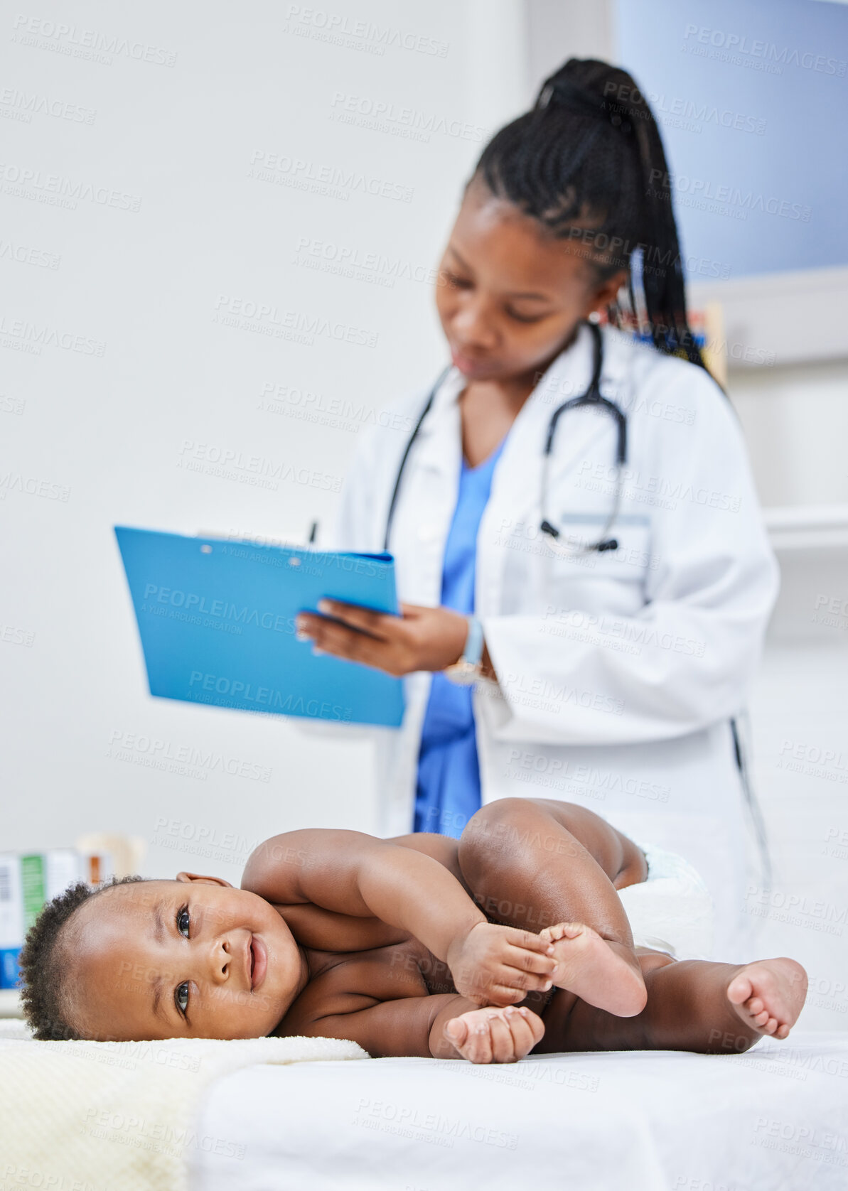 Buy stock photo Shot of a doctor making notes about her infant patient on a clipboard