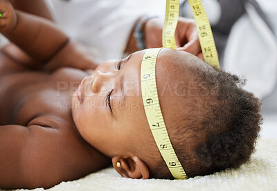 Buy stock photo Shot of a baby having her head measured by a doctor