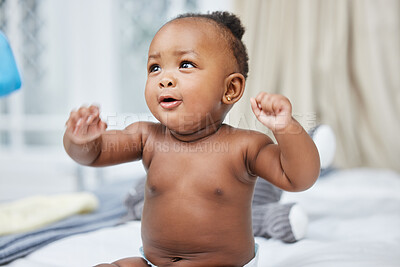 Buy stock photo Play, African and newborn baby in clinic for care, growth development and health assessment. Happy patient, smile or girl on bed in hospital ready for infant exam, pediatric treatment or wellness