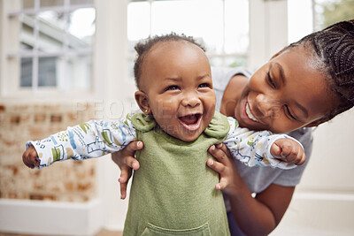 Buy stock photo Love, woman with baby and in living room smile at their home. Happy family or care, happiness or comic and black female person with newborn laughing or smiling at their house indoors for support
