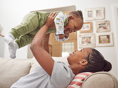 Buy stock photo Shot of a young woman bonding with her baby at home