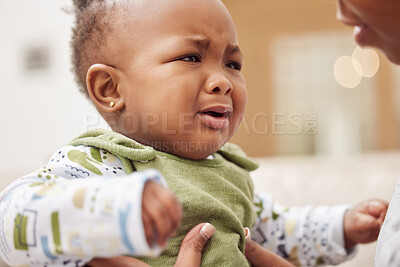 Buy stock photo Shot of a baby girl crying while sitting at home