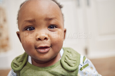 Buy stock photo Face, baby and black child in home, cute or enjoying time alone in South Africa. African newborn, children and portrait of toddler, kid and young infant with childhood development for growth in house