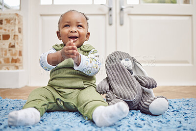 Buy stock photo Smile, baby and black child clapping in home, having fun or enjoying teddy bear. African newborn, children and toddler, kid and young infant play, happy or applause for childhood development in house