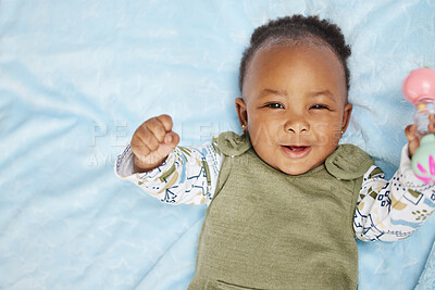 Buy stock photo Shot of an adorable baby boy lying on a bed