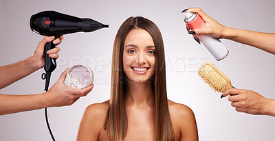 Buy stock photo Studio portrait of an attractive young woman having her hair tended to backstage against a grey background