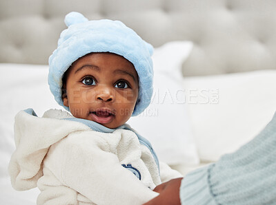 Buy stock photo Hands, baby and mom with boy, growth or winter clothes for fashion, security or safety in bedroom of family home. African, parent or youth in house for bonding, love or care for child development