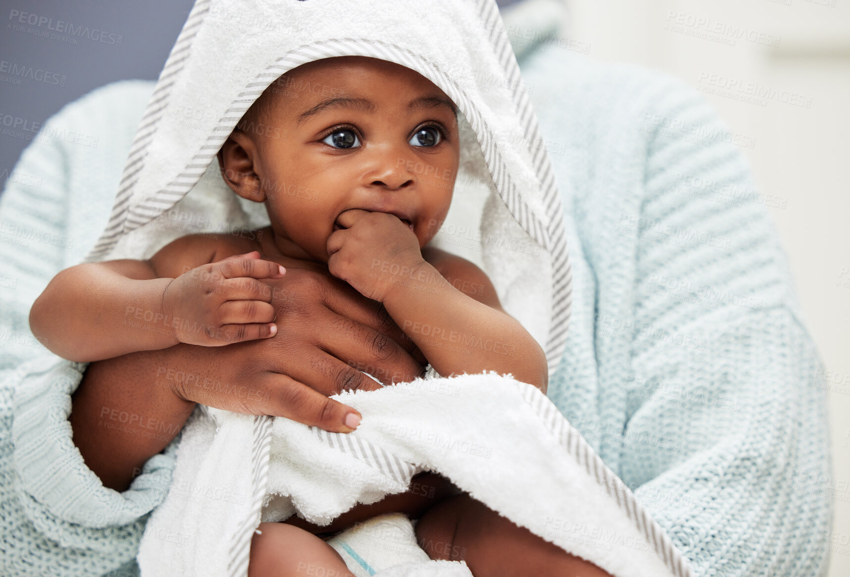 Buy stock photo Shot of an adorable baby boy wrapped in a bath towel