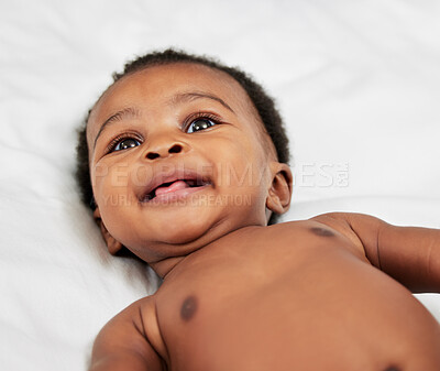 Buy stock photo Newborn, black baby and happy in bed in home with wake up, morning routine and relax in nursery. Infant, child and face with curious smile in bedroom with resting, playful and comfortable in house