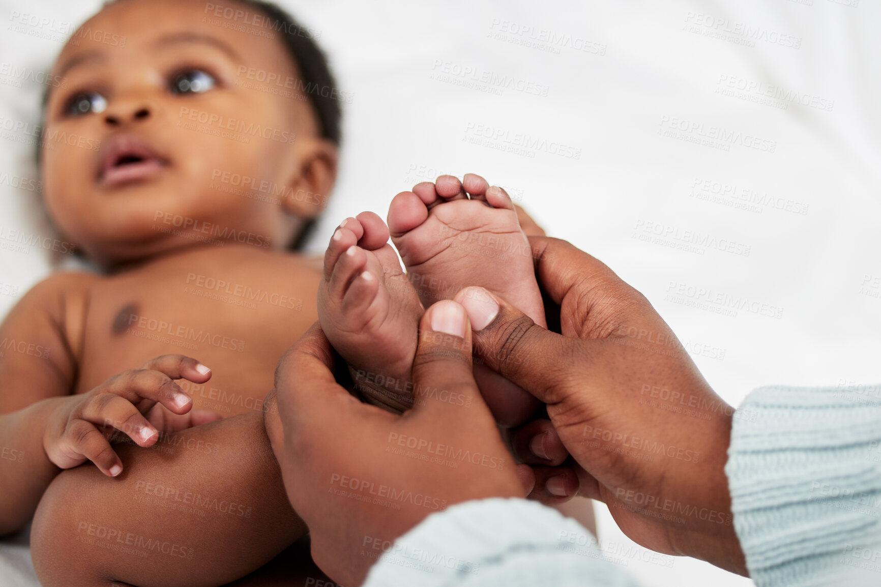 Buy stock photo Hands, mother and feet of baby with massage for health, wellness or body care with bath at home. Bed, child growth and African mom rub pressure point for reflexology of newborn kid in nursery room.