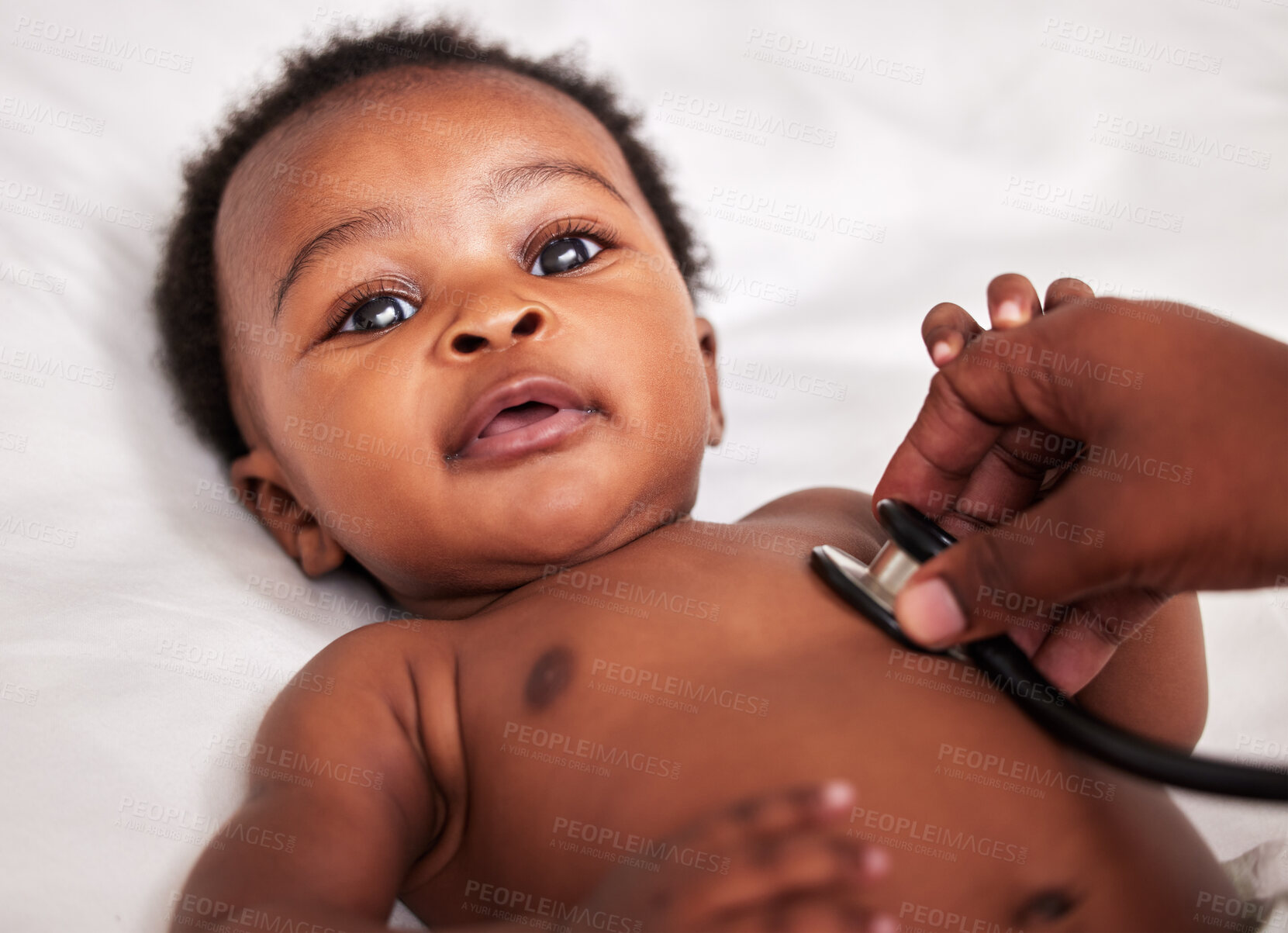 Buy stock photo Shot of a little baby at a checkup with a doctor at a clinic