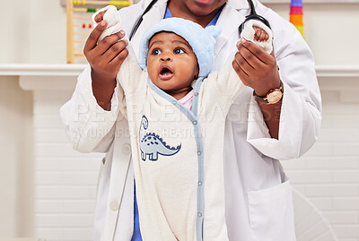 Buy stock photo Shot of a little baby at a checkup with a doctor at a clinic