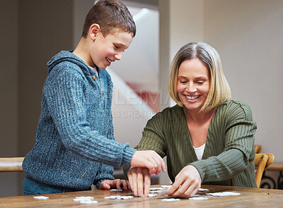 Buy stock photo Happy, woman and kid with puzzle by table at home for development, support and problem solving. Family, mother and son with memory game in living room for cognitive, learning and growth in logic