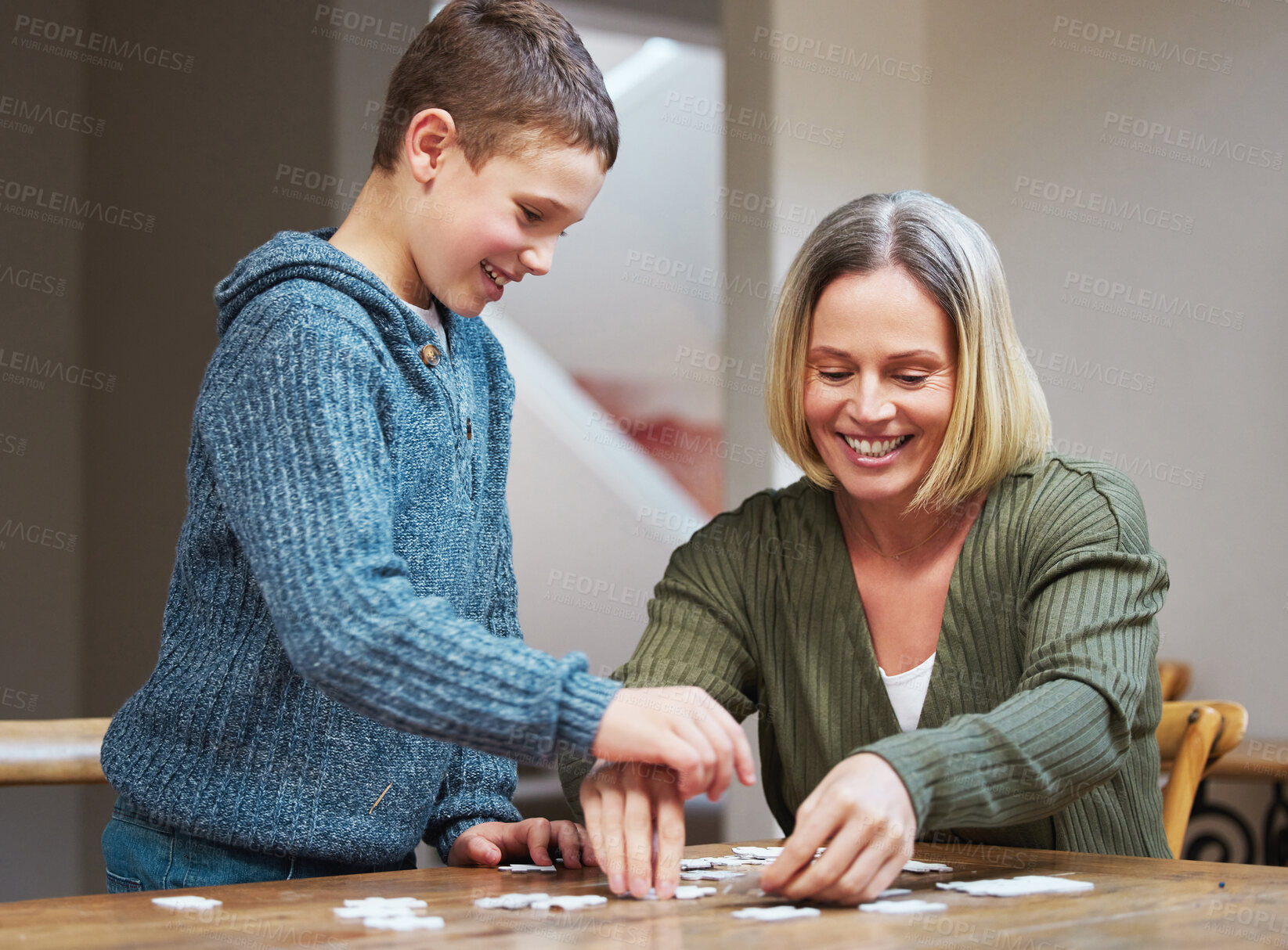 Buy stock photo Happy, woman and kid with puzzle by table at home for development, support and problem solving. Family, mother and son with memory game in living room for cognitive, learning and growth in logic