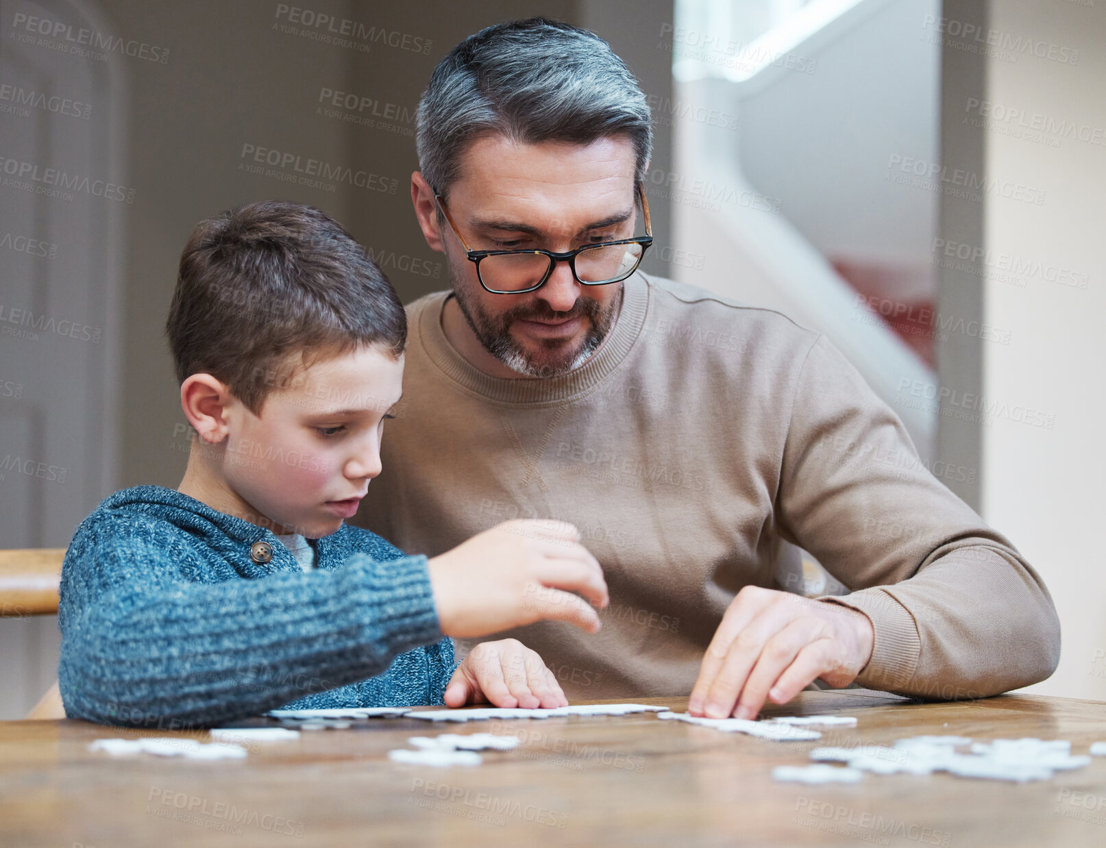 Buy stock photo Family, man and kid with puzzle by table at home for development, support and growth in logic. Thinking, father and son with memory game in living room for cognitive, learning and problem solving