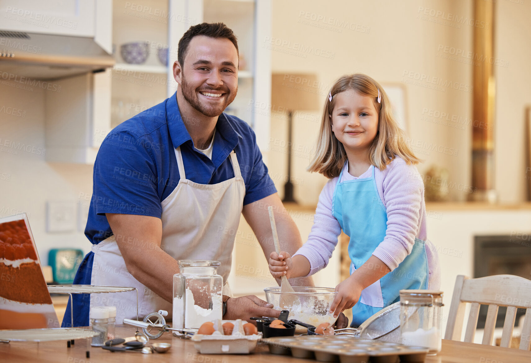 Buy stock photo Shot of a young man helping his daughter stir a bowl of cake mix