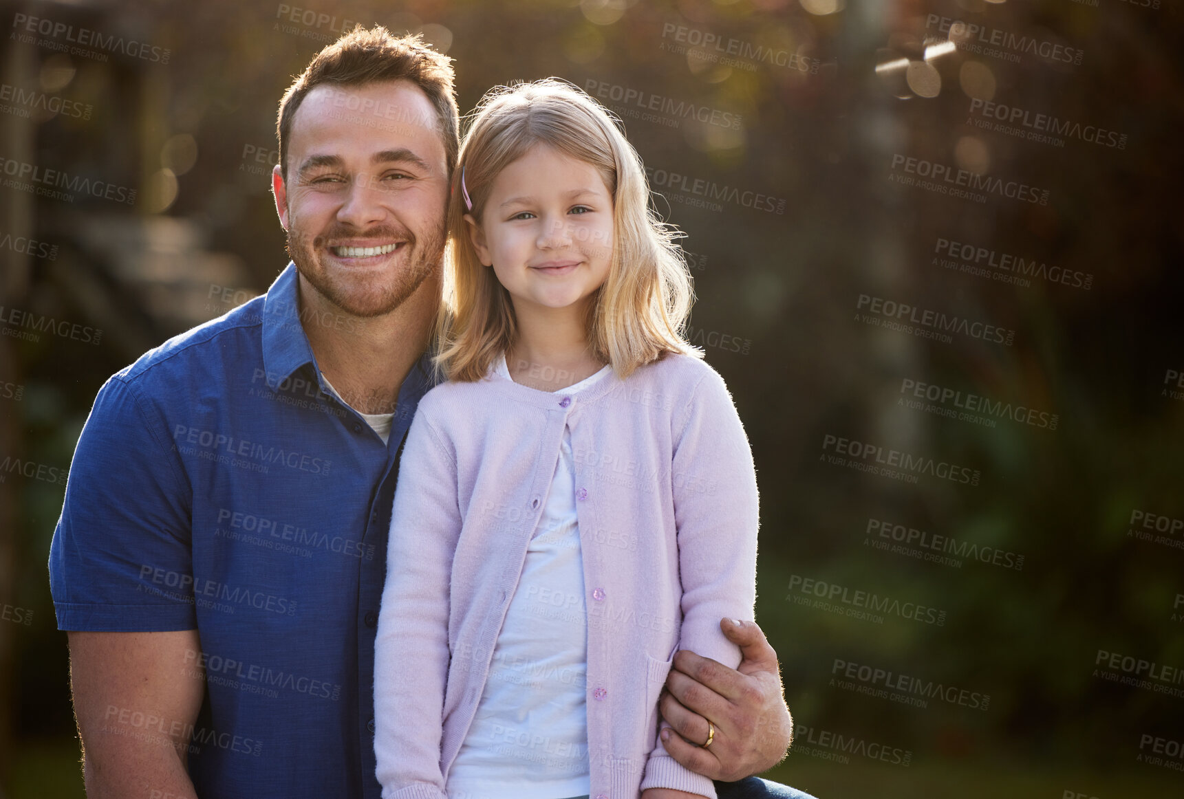 Buy stock photo Cropped portrait of a handsome young man and his daughter posing outside in the garden at home