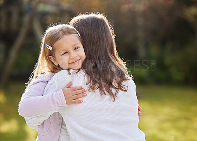 Buy stock photo Cropped shot of an adorable little girl hugging her mother outside in the garden at home