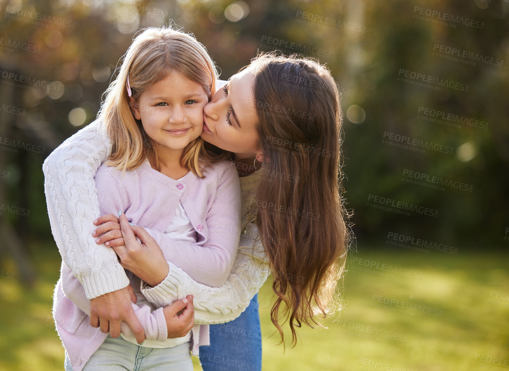 Buy stock photo Mom, girl and kiss in outdoor for love or family care, holiday with trust in London garden. Mother, child and growth support with happiness or hug on vacation, travel bokeh or mothers day in park