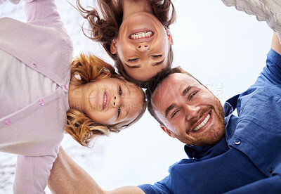 Buy stock photo Happy family, bottom and portrait in outdoor for holiday with support, collaboration for travel break or journey. Man, woman and girl for solidarity on vacation in England, smile in circle with sky