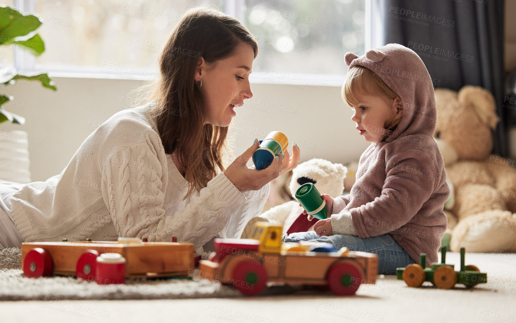 Buy stock photo Shot of a young mother and daughter playing at home