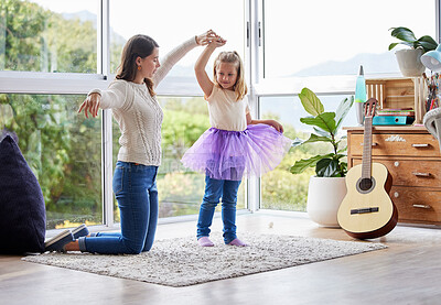 Buy stock photo Shot of a young mother and daughter practicing ballet at home